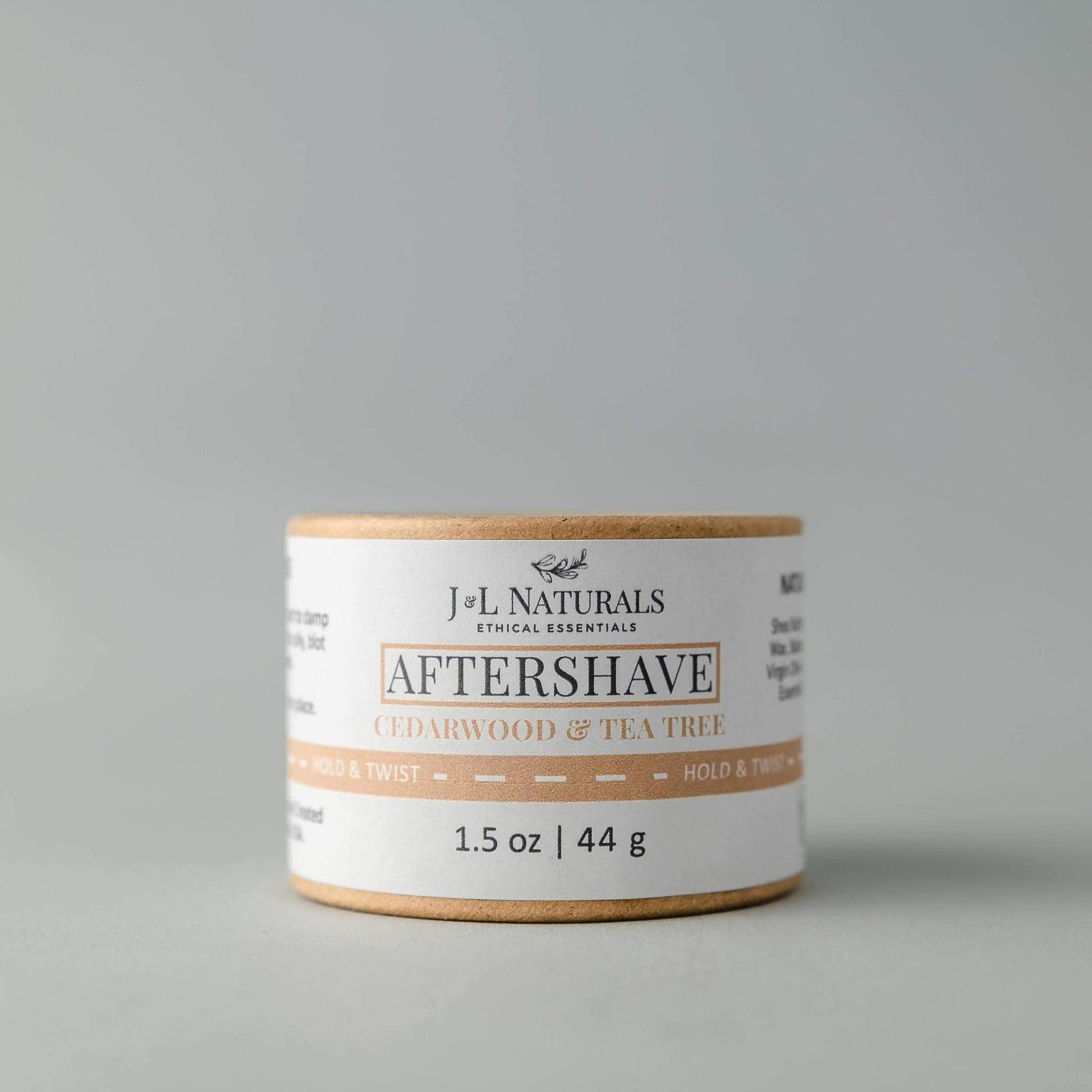 Jar of J&L Naturals aftershave with cedarwood and tea tree on a gray background