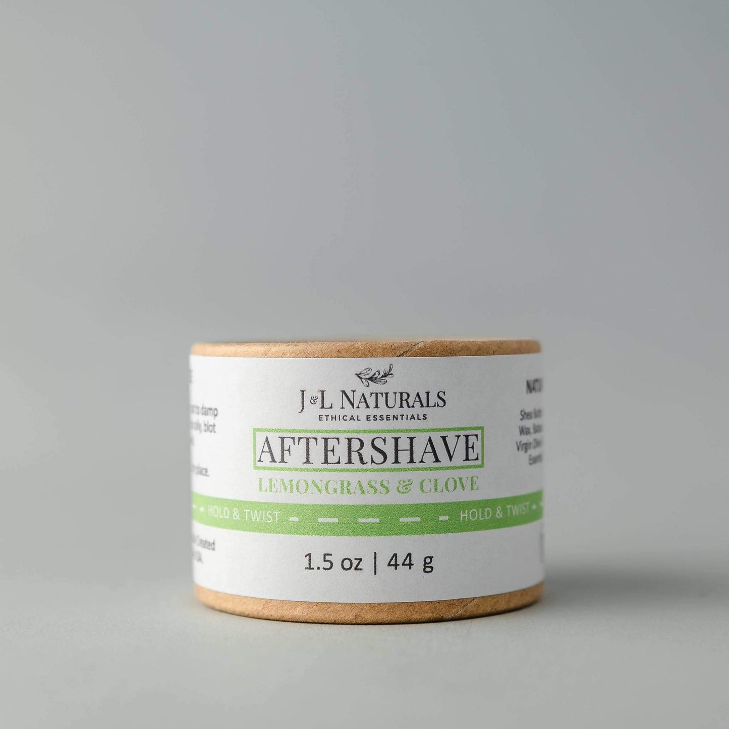J&L Naturals aftershave product with lemongrass and clove scent on a gray background