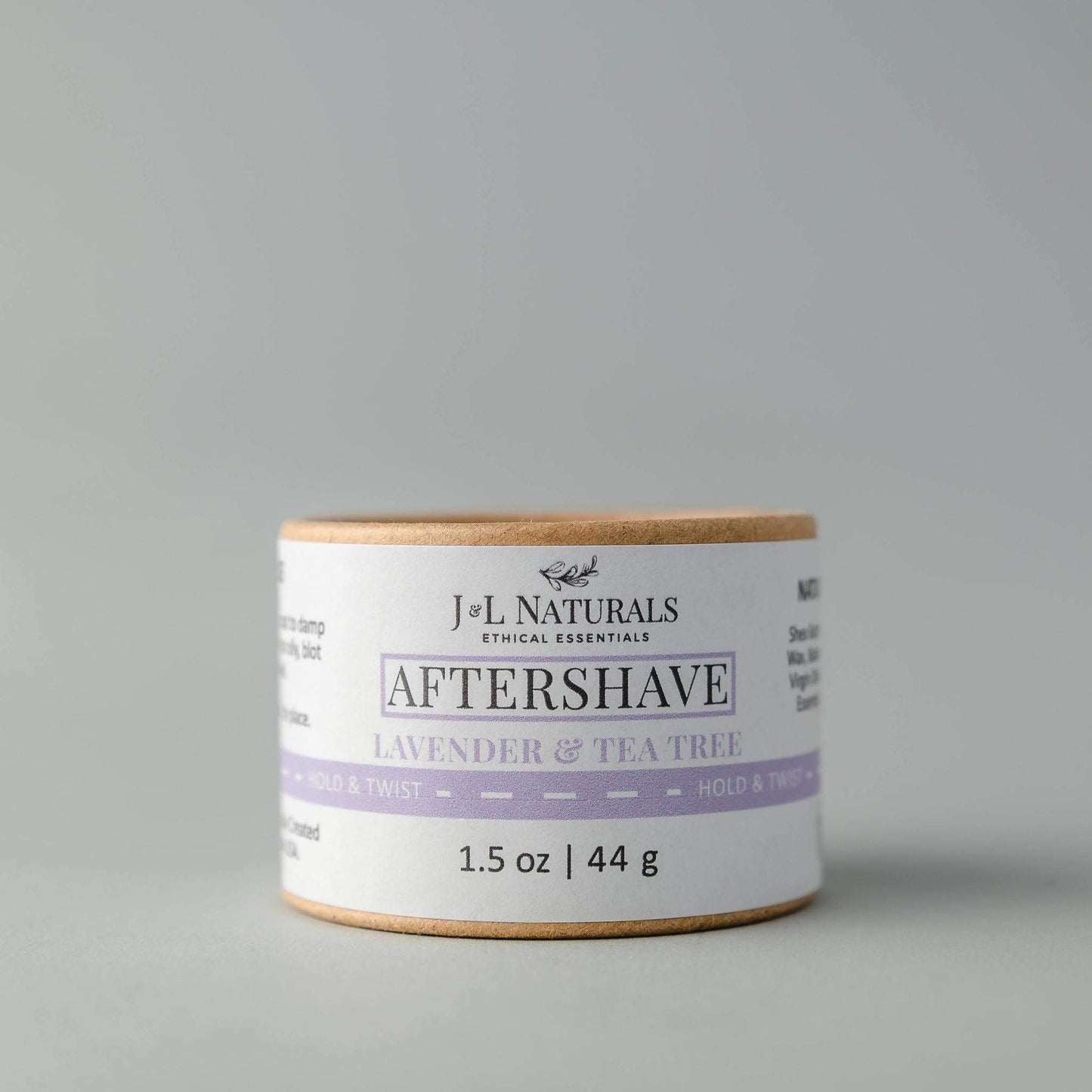 J&L Naturals aftershave jar with lavender and tea tree scent on a gray background