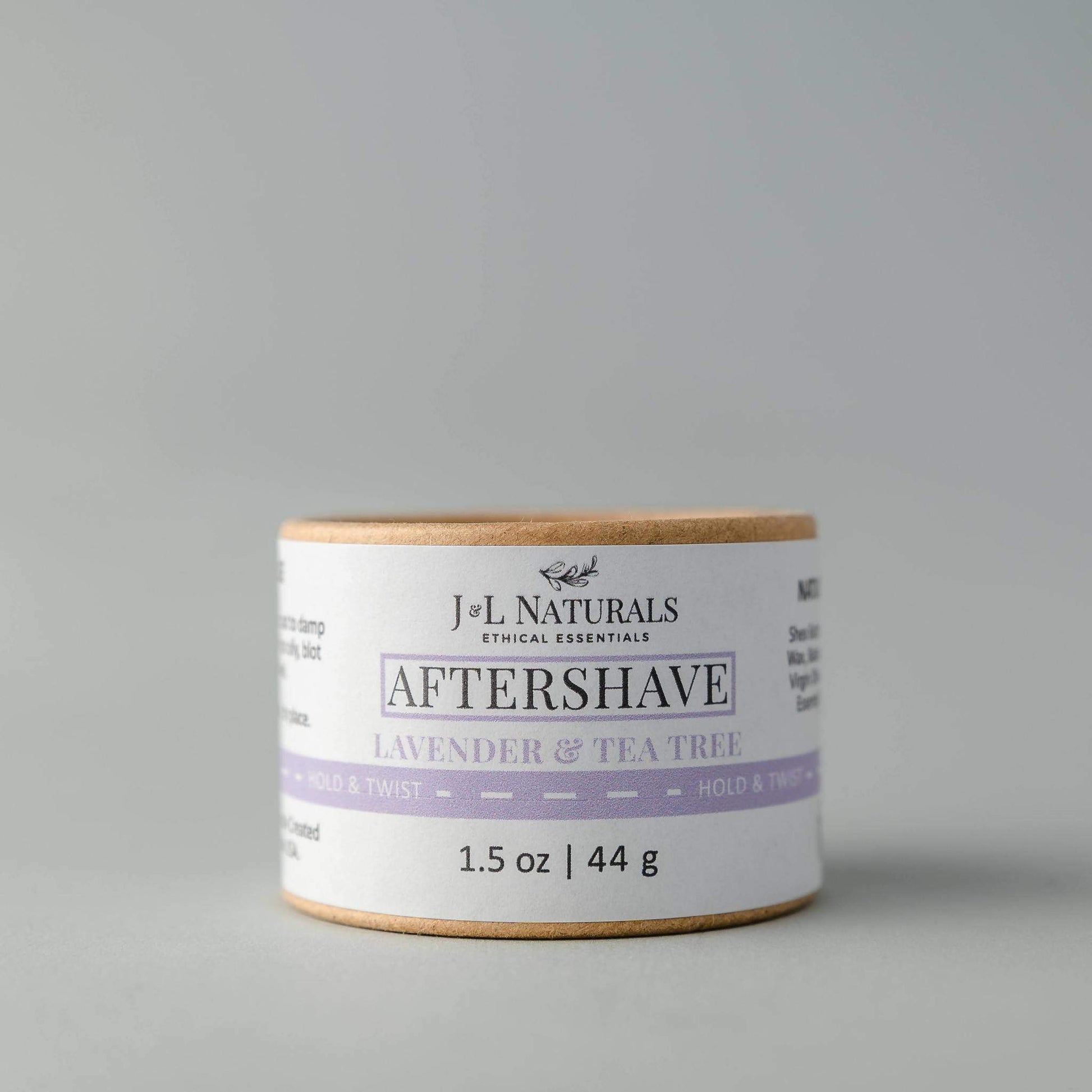 J&L Naturals aftershave jar with lavender and tea tree scent on a gray background