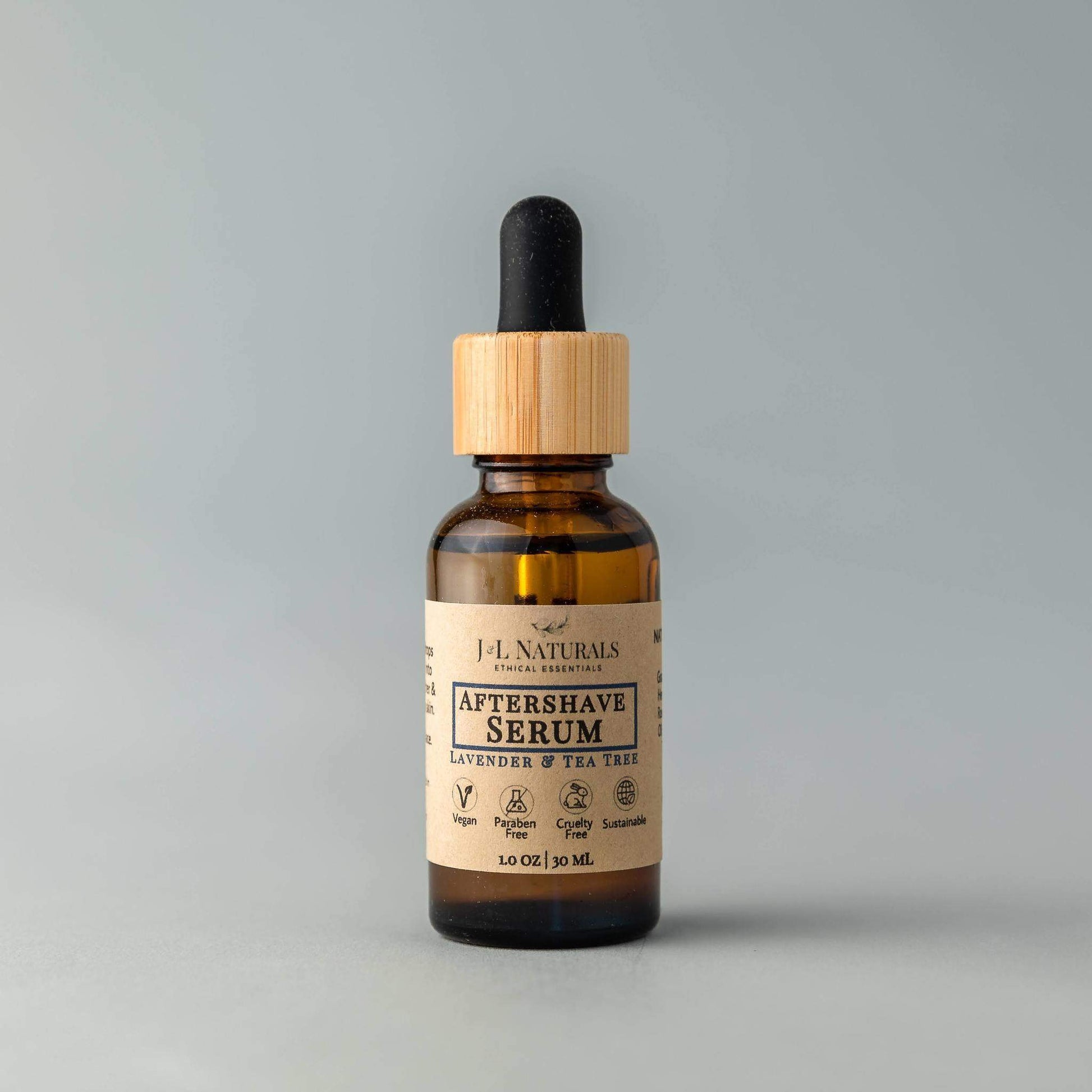 Aftershave serum bottle with wooden dropper on a gray background