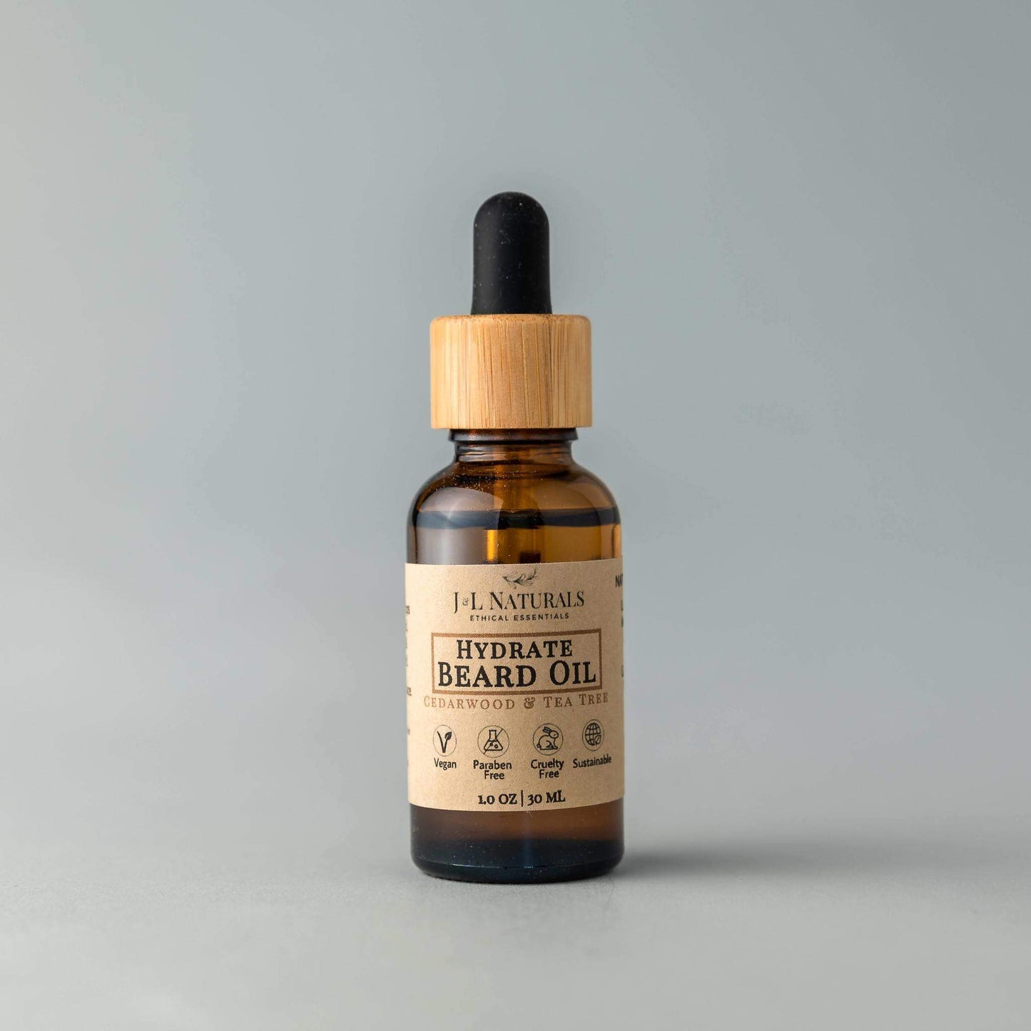 Bottle of hydrate beard oil with a wooden dropper on a gray background