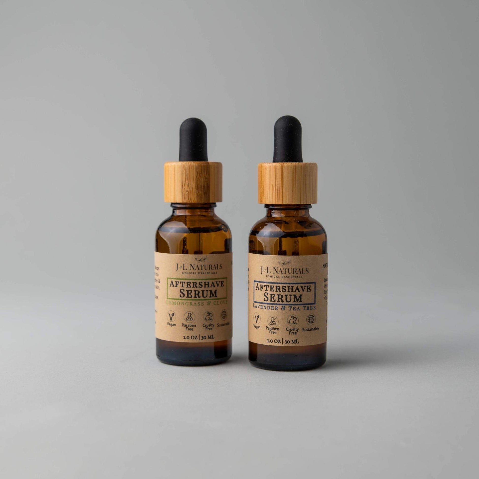 Two bottles of F.J. Naturals Aftershave Serum on a gray background